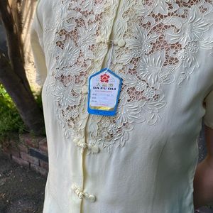 Hand embroidered mandarin collar shirt sleeve blouse in the color yellow